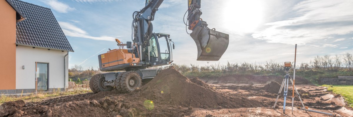 House construction, excavation with excavator House construction, excavation with excavator